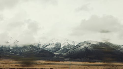 Snowcapped Mountains Covered in Fog 