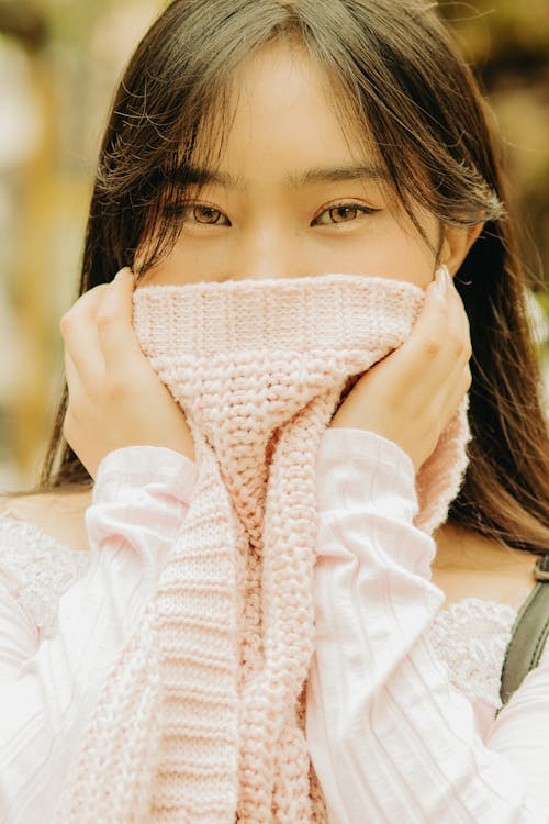 Young Woman Covering Half of Her Face with a Sweater 