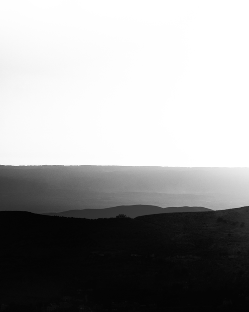 Free Black and white landscape showcasing hills, mountains, and open sky in serene harmony. Stock Photo