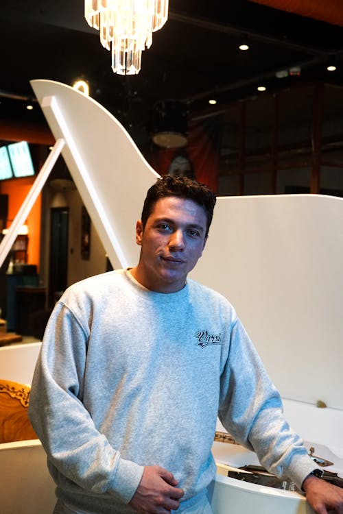 Portrait of a Young Man Standing in Front of a Piano