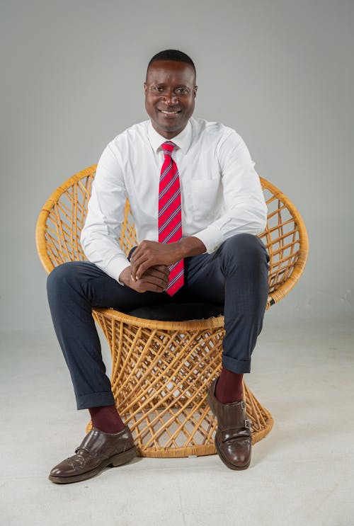 Portrait of a Businessman Sitting on a Rattan Chair