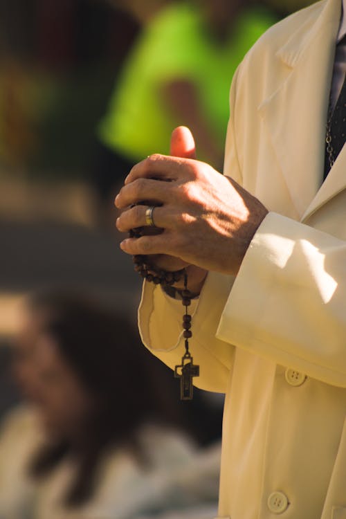 Person Holding a Rosary