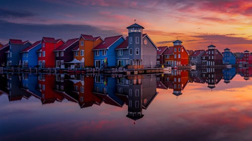 Colorful Houses by Lake at Sunset
