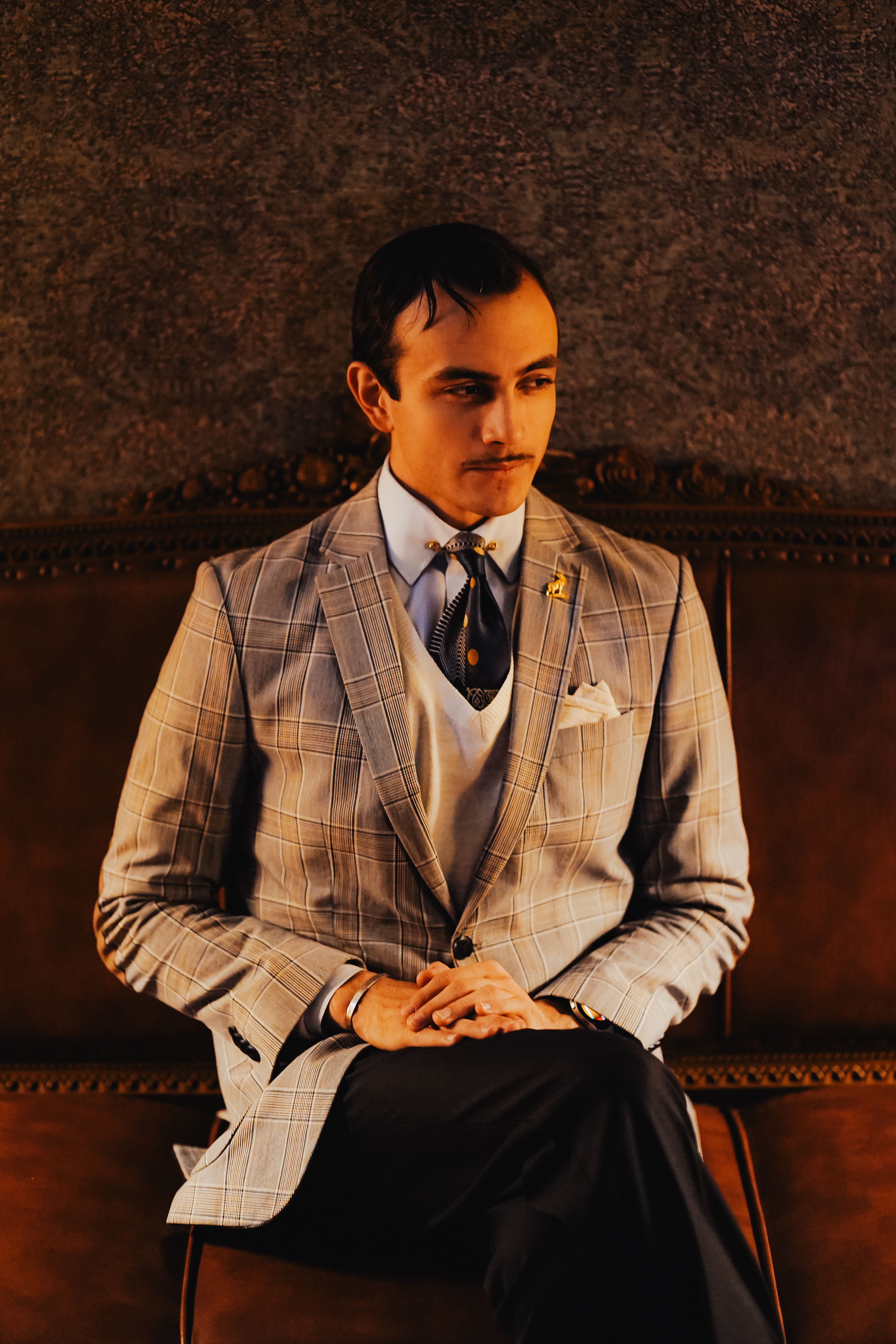 Man Wearing a Suit Sitting on a Couch  Free Stock Photo