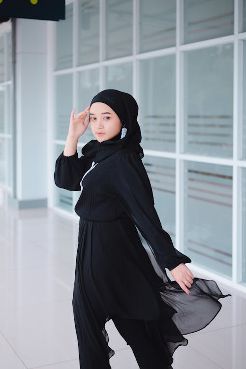 Woman Posing on a Headscarf, a Blouse and Flowing Pants