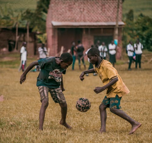 African Boys Playing Football on a Field 