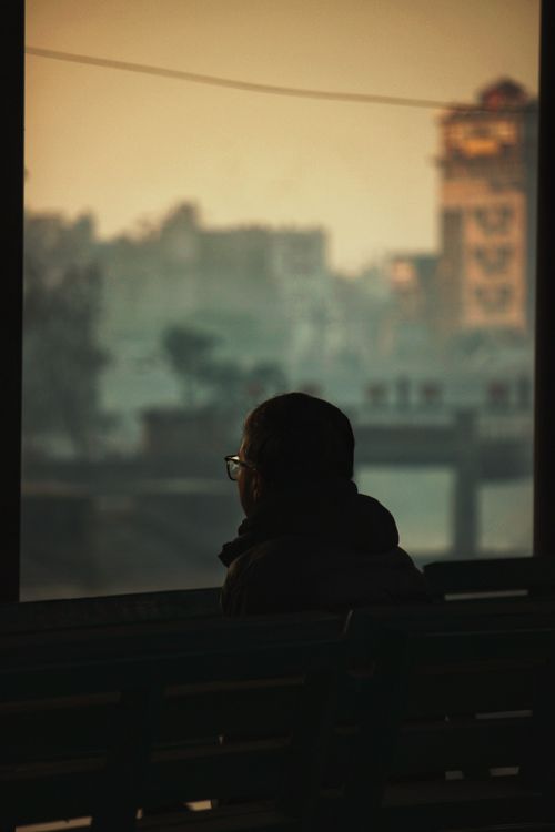 Free Silhouette of a person gazing at Kathmandu cityscape during sunset, creating a serene urban scene. Stock Photo