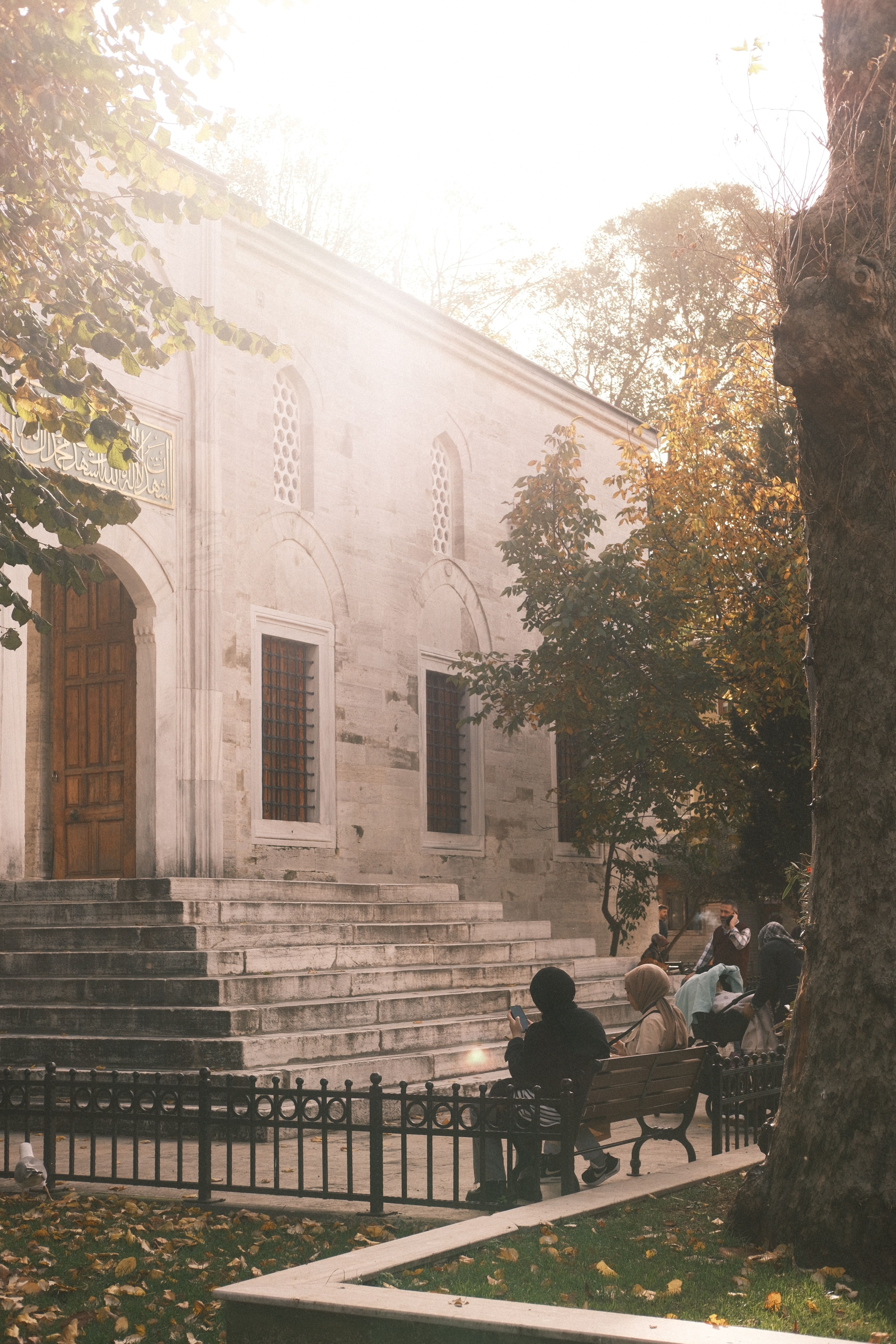People Sitting on Benches near the Entrance to the Yeni Valide Mosque ...