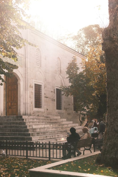 People Sitting on Benches near the Entrance to the Yeni Valide Mosque ...