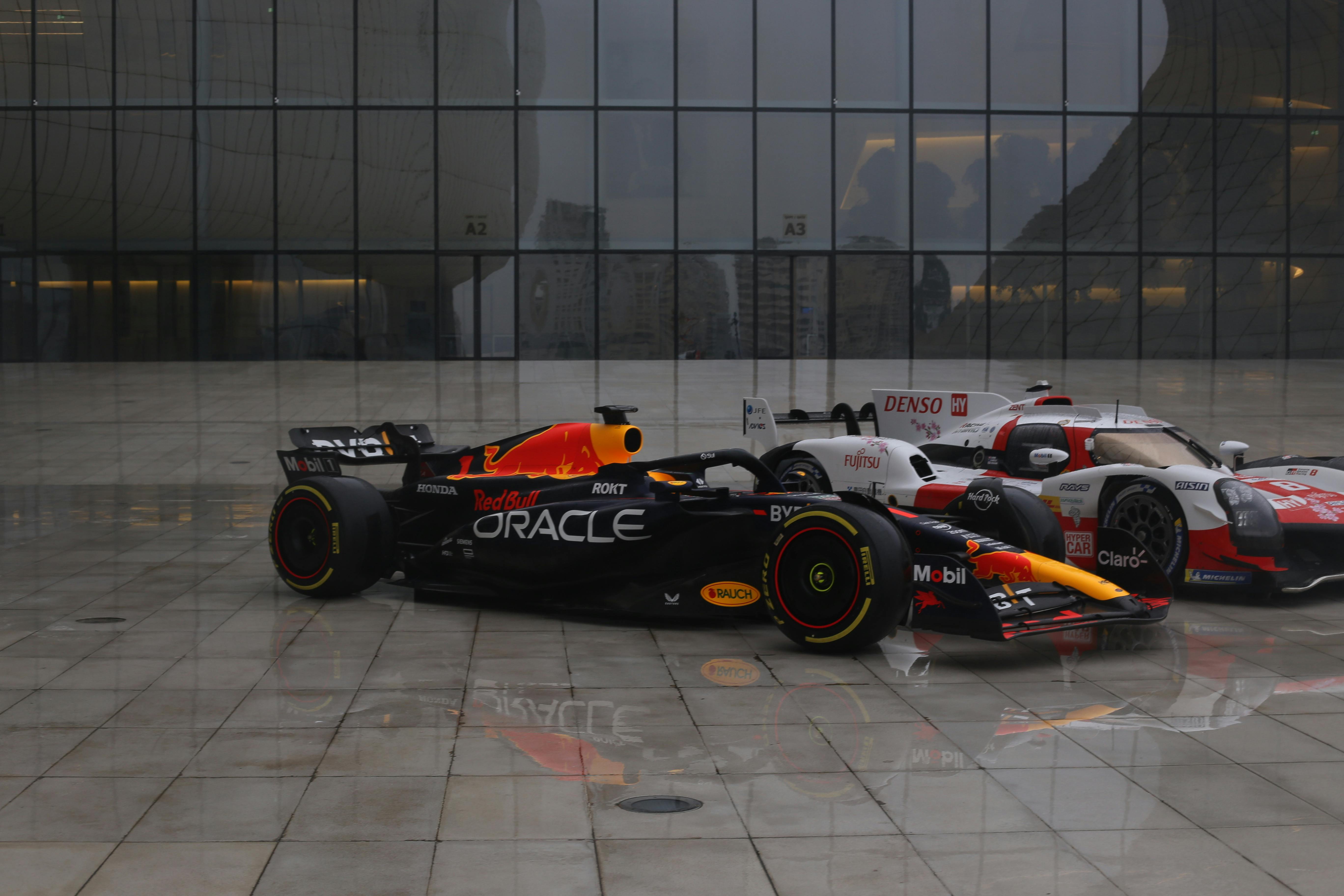 Formula 1 Red Bull RB19 Race Car and Toyota GR010 Hybrid Le Mans Hypercar in front of the Heydar Aliyev Center in Baku, Azerbaijan