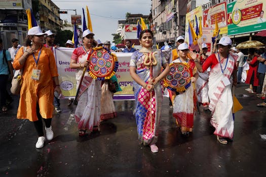 Colorful parade in Kolkata celebrating Indian culture with traditional clothing and dance.