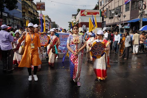 People in Folk Costumes Walking on a Street in City during a Celebration 