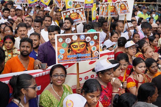 A vibrant crowd celebrating Indian culture at a festival in Kolkata, India.