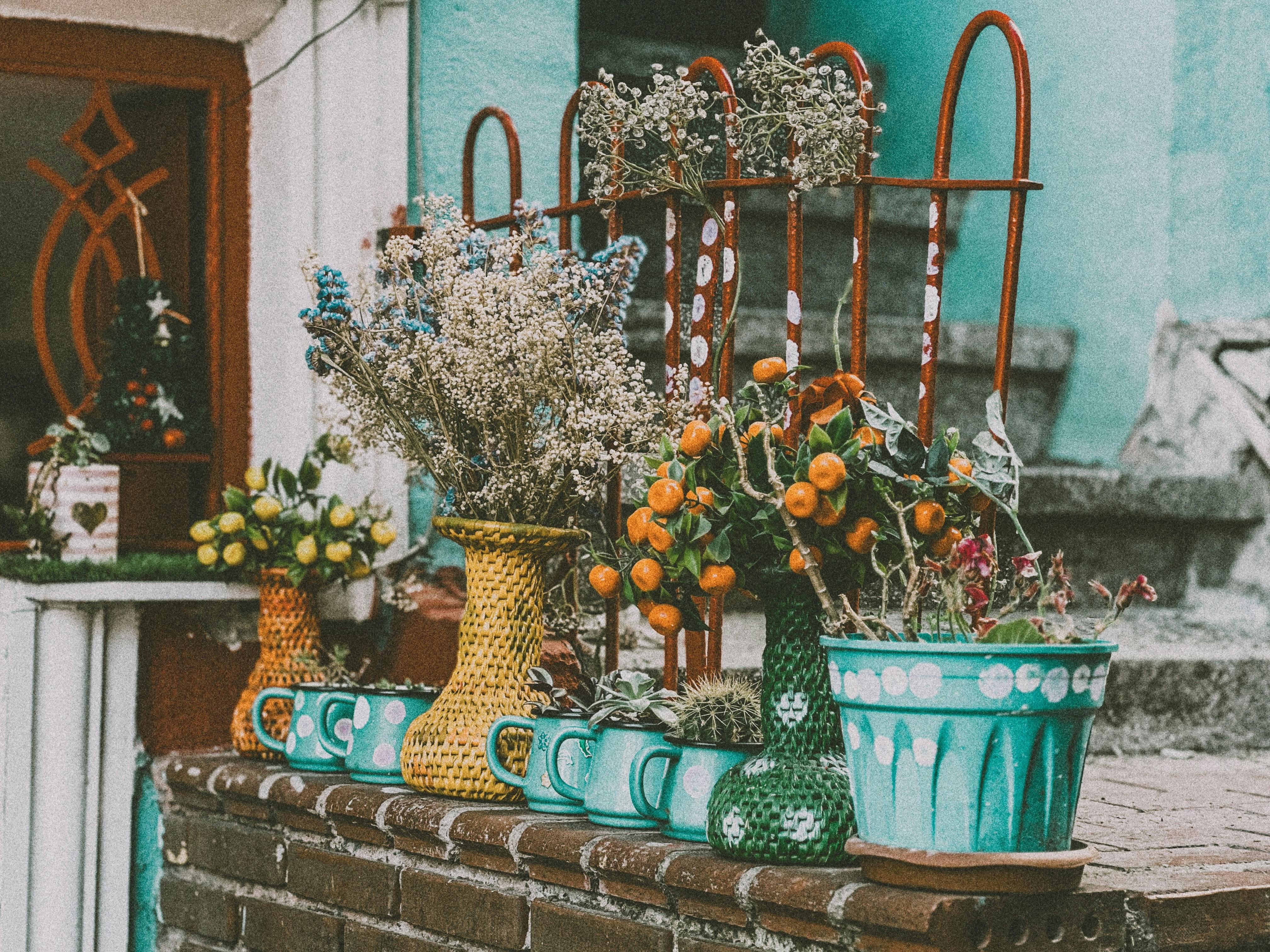 various herb pots arranged on a balcony railing - best herbs for balcony