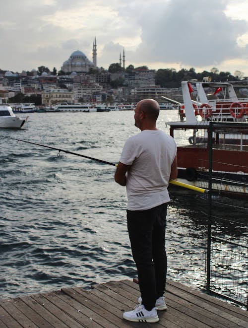 Man Fishing in Sea Bay