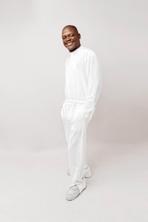 Smiling Man in White Sweater and Pants