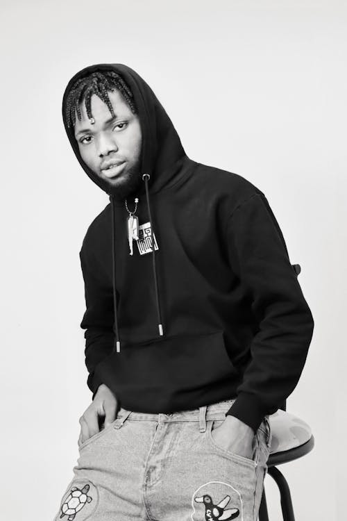 Black and White Photo of a Young Man in a Hoodie and Jeans 