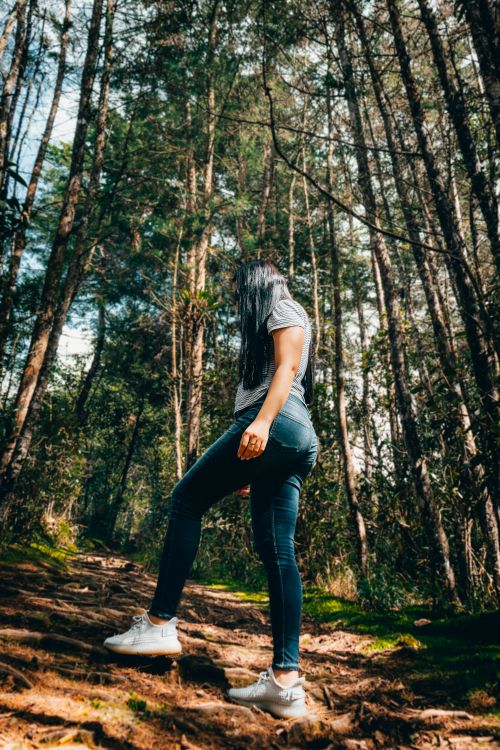 Free A woman hikes through a lush forest in Santa Elena, Antioquia, Colombia. Captured with vibrant detail. Stock Photo