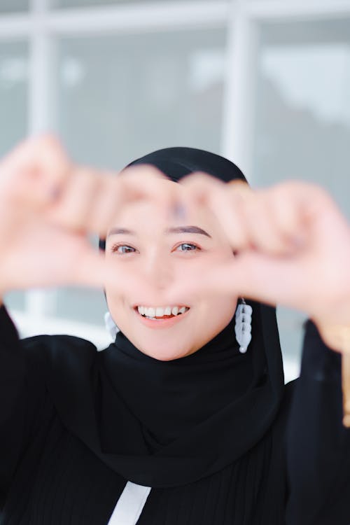 Photo of a Woman Wearing a Black Hijab, Gesturing