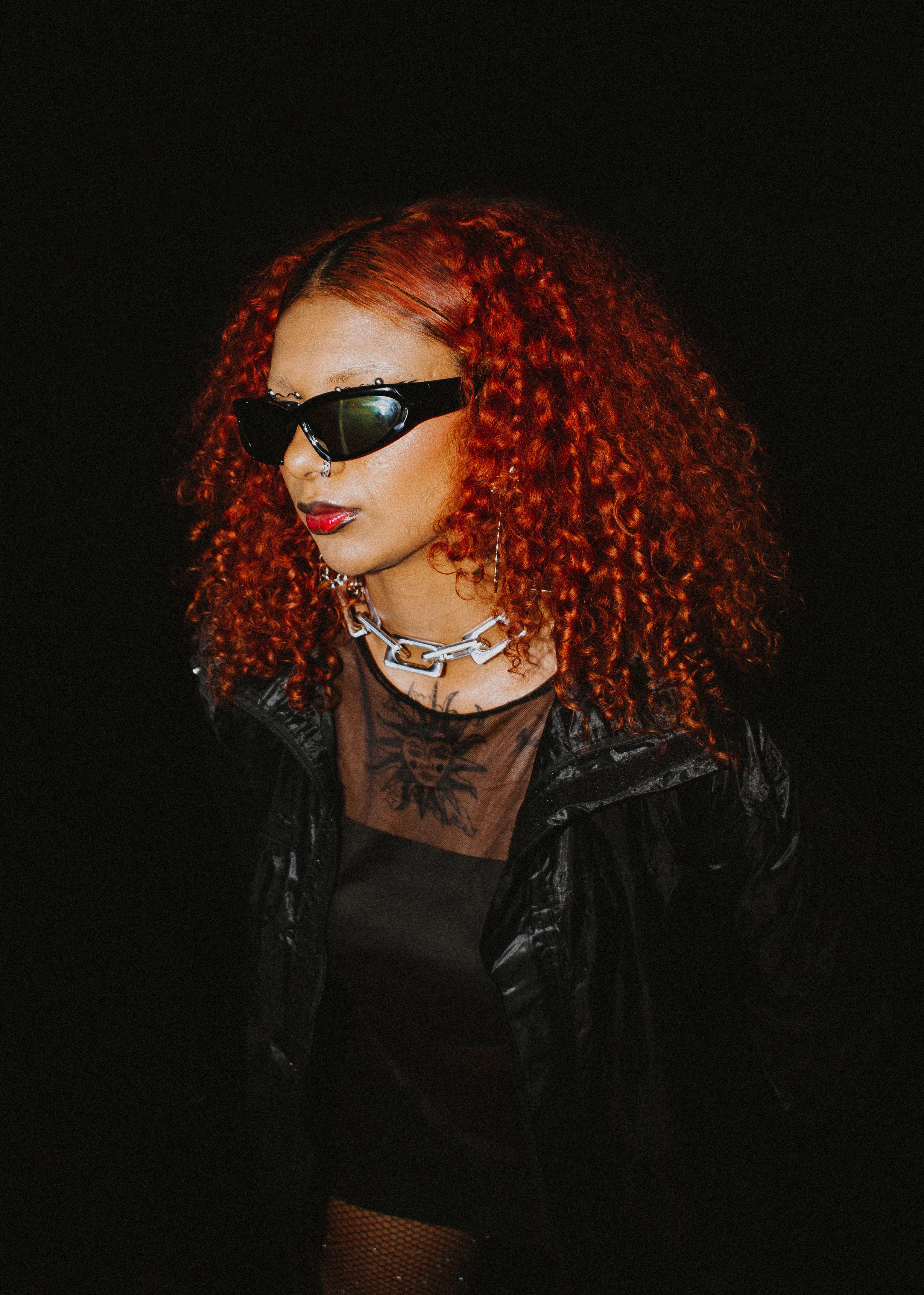 Redhead Model Posing in Sunglasses against Black Background · Free ...