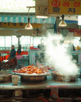 Hot and steamy Korean street food served at a bustling outdoor market, capturing vibrant culinary culture.