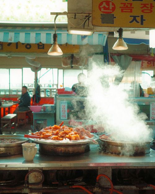 Free Hot and steamy Korean street food served at a bustling outdoor market, capturing vibrant culinary culture. Stock Photo