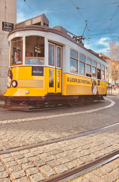 Yellow and White Tram on Road
