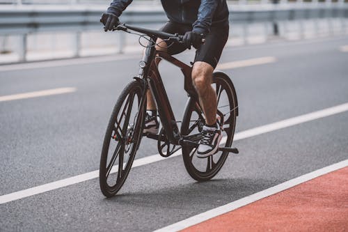 Man Riding a Bike on Asphalt