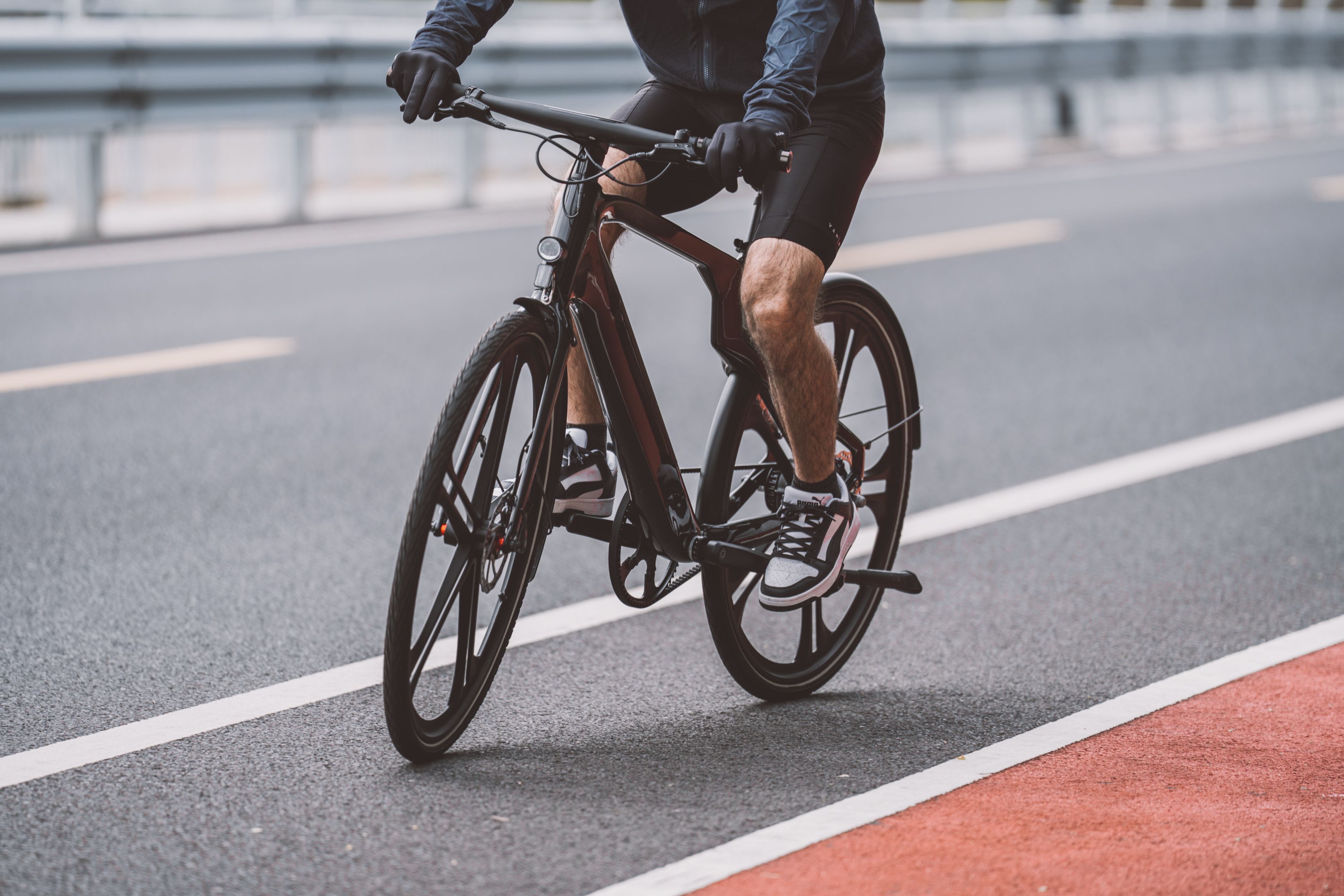 A man riding a bike on a road · Free Stock Photo