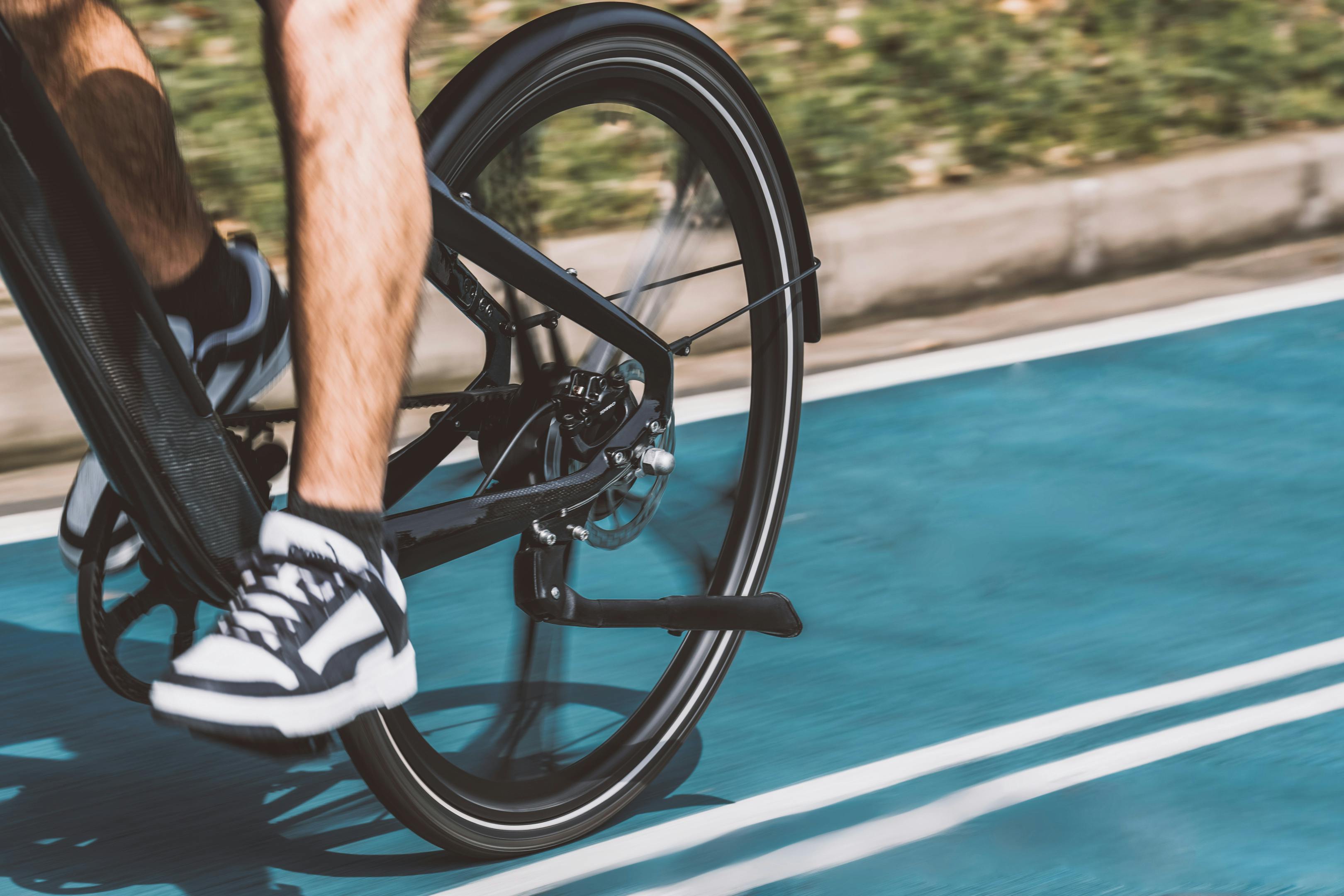 back wheel closeup of a person riding a bicycle