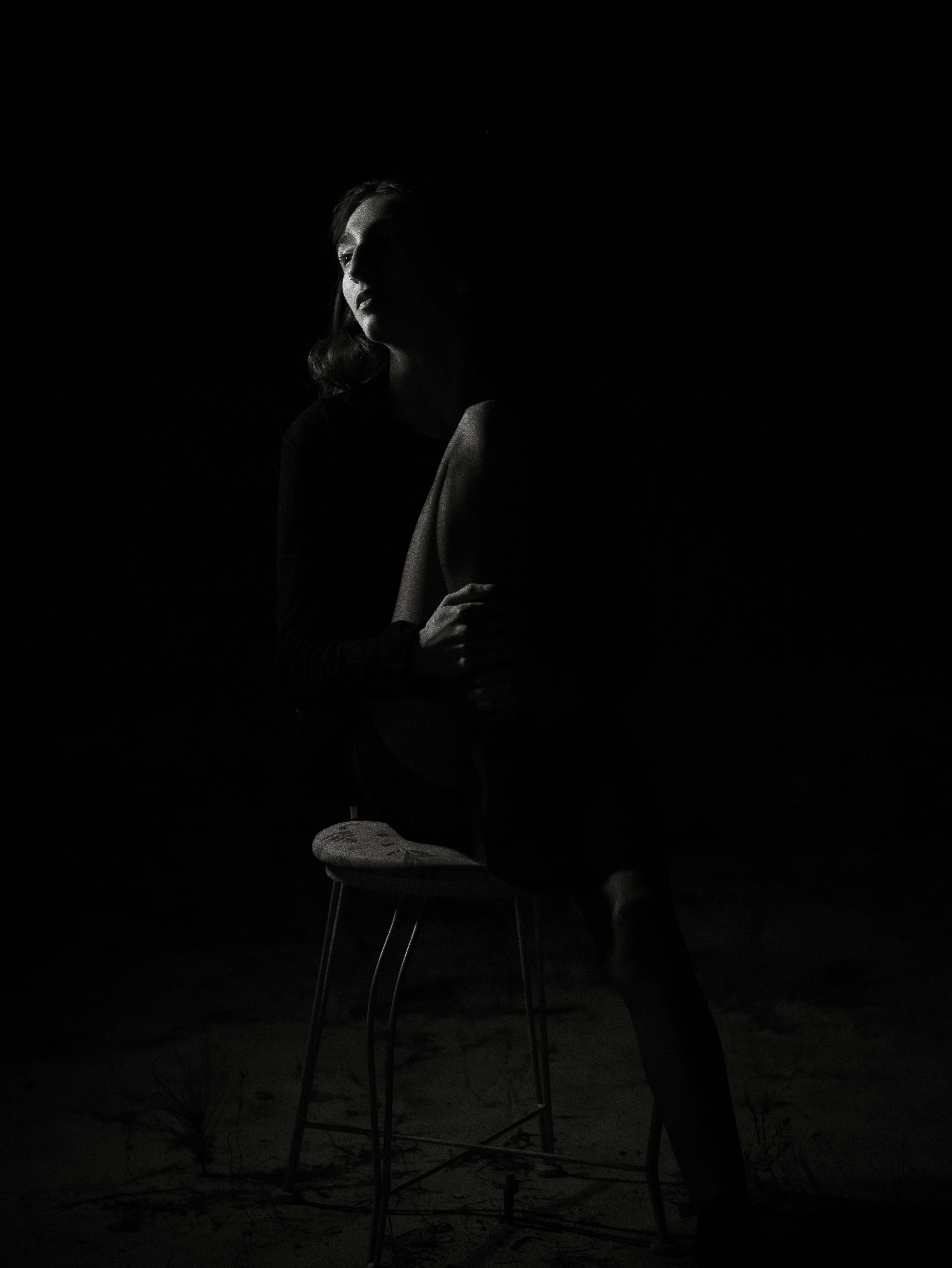 woman sitting in the dark