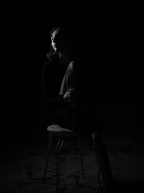 Woman sitting in the dark 