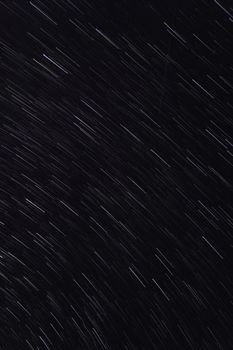 Mesmerizing star trails captured in a long exposure night sky photograph.