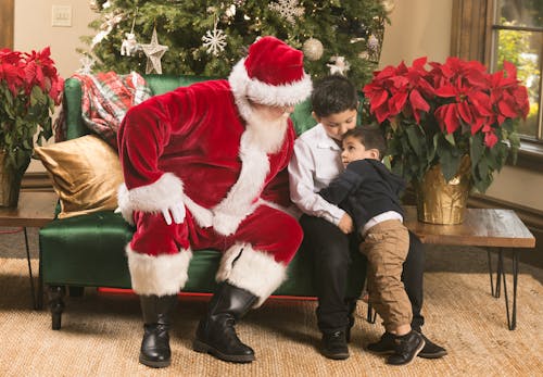 Boys Sitting Next to Santa Claus in Living Room