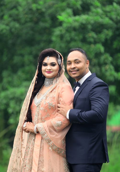 Free Smiling South Asian couple in elegant wedding attire, outdoors, showcasing love and style. Stock Photo