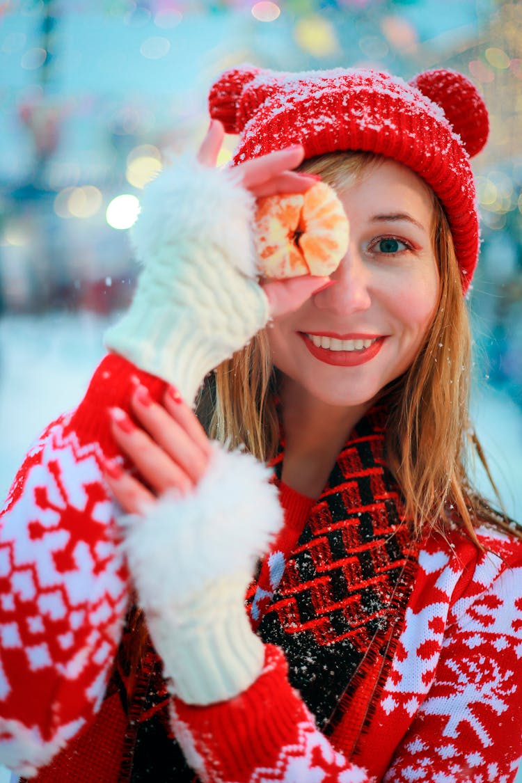 Smiling Woman In Red Sweater Posing With Clementine In Hand