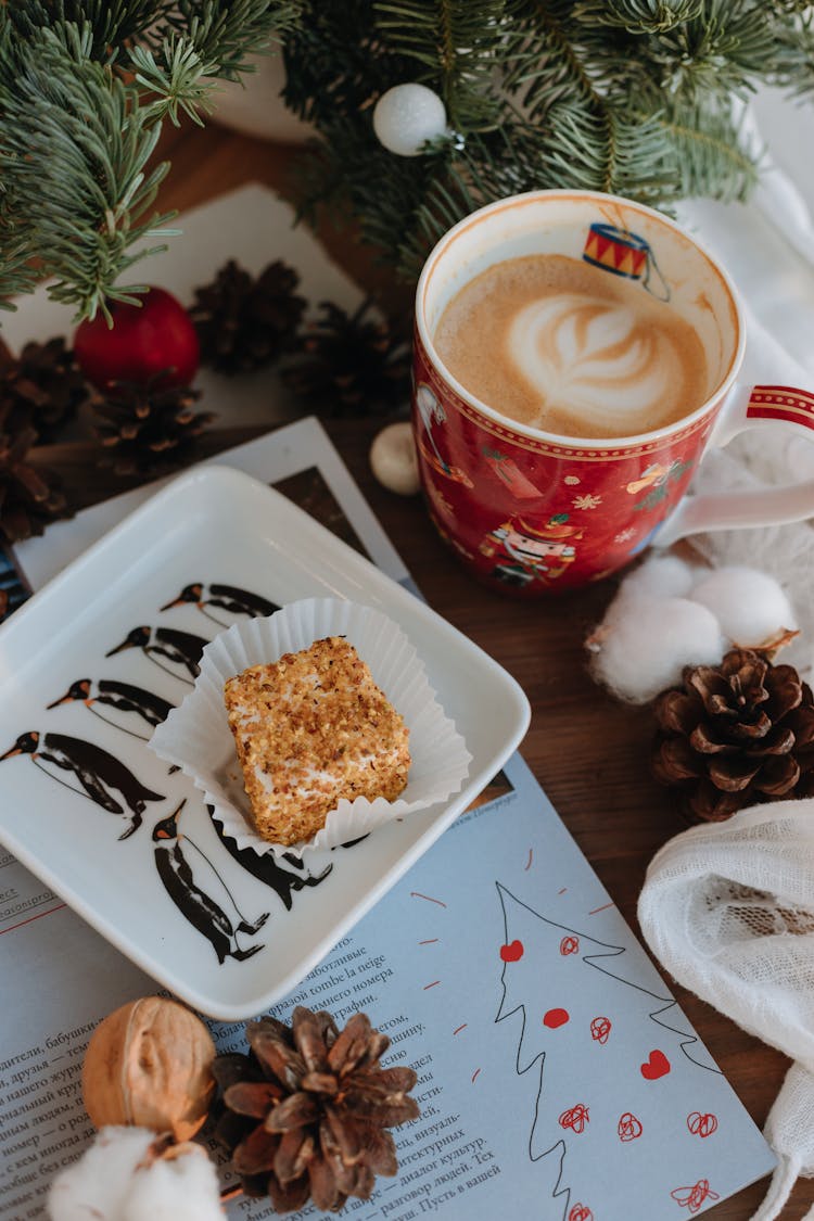 Cappuccino And Cakes On Plate By Christmas Branch