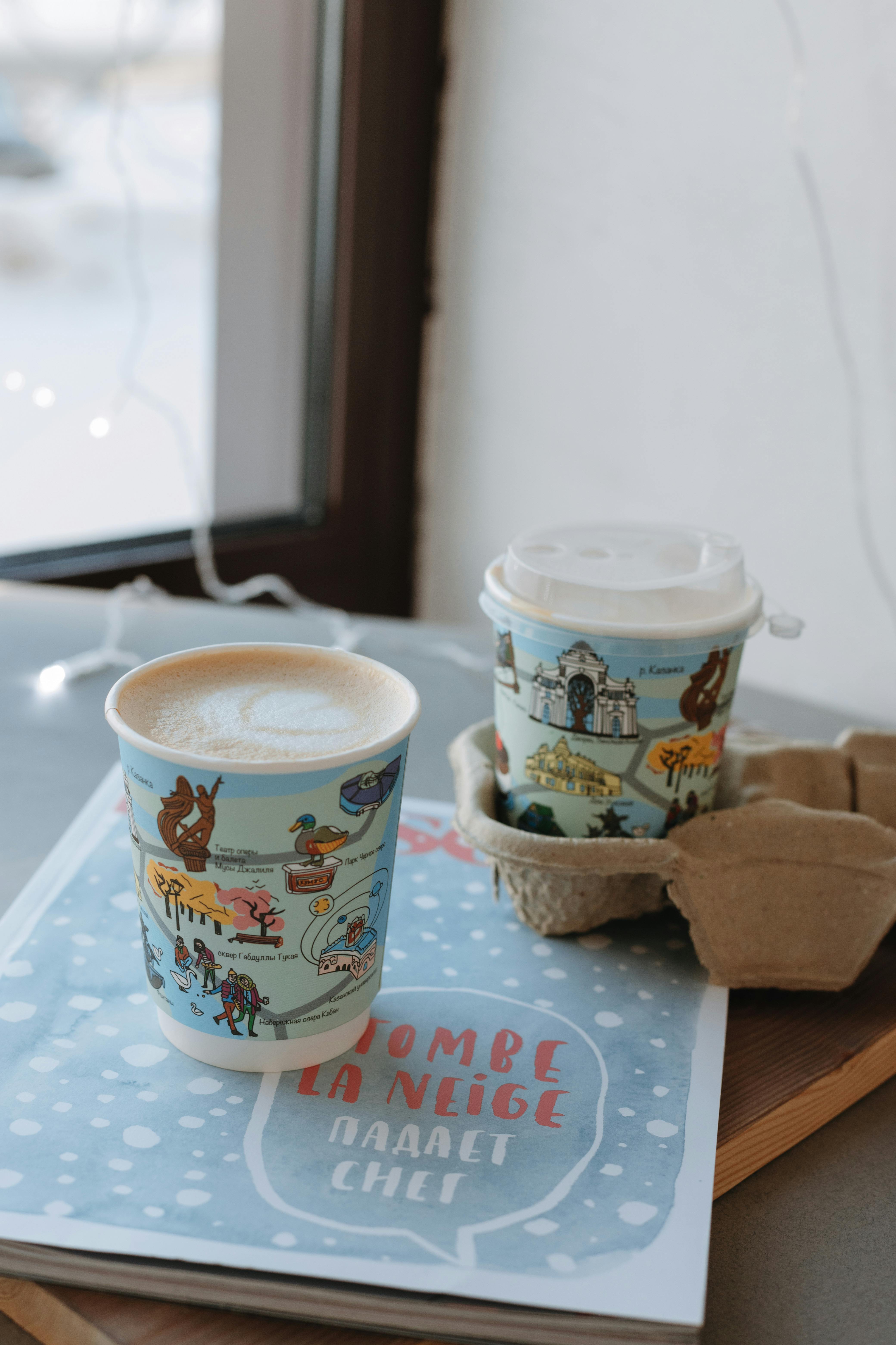 Disposable Cups on Brochure by Window · Free Stock Photo