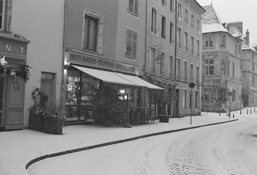 Kostnadsfri bild av byggnader, gata, snö