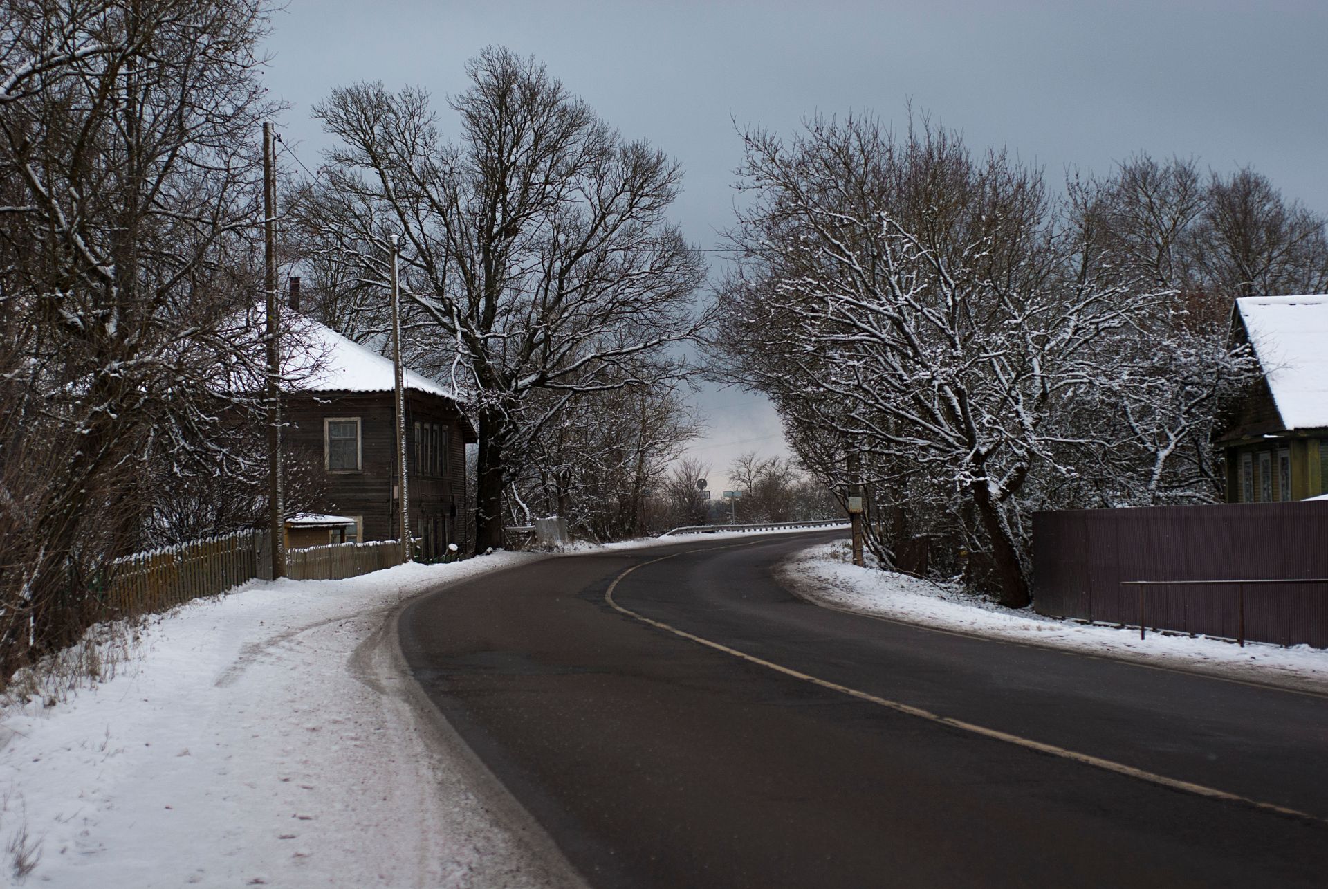 A rural village road under an overcast sky