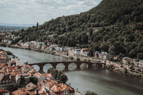 Free Aerial view of Heidelberg's historic Old Bridge crossing the scenic Neckar River. Stock Photo