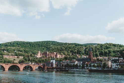 Free Scenic view of Heidelberg, featuring the Old Bridge and castle surrounded by lush hills. Stock Photo