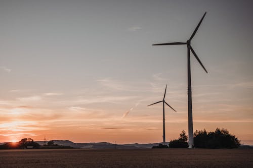 Windmills on a Field During Sunset