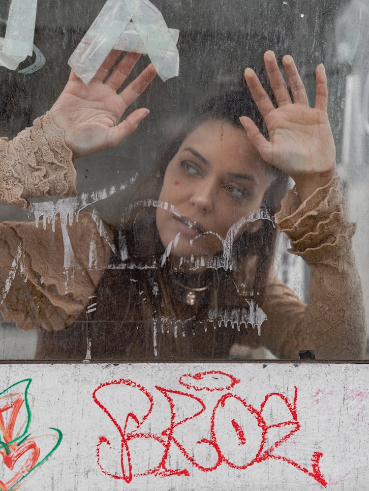 Portrait Of Woman Behind A Glass On A Street