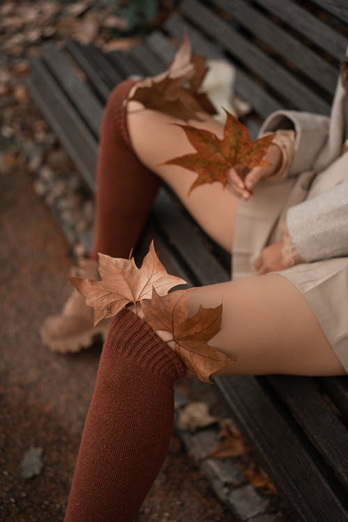 Woman Among Golden Leaves in Fall 