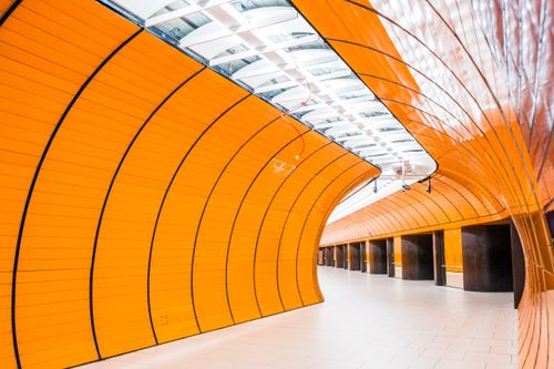 Free Brightly colored modern subway tunnel interior, featuring orange paneling and sleek design. Stock Photo