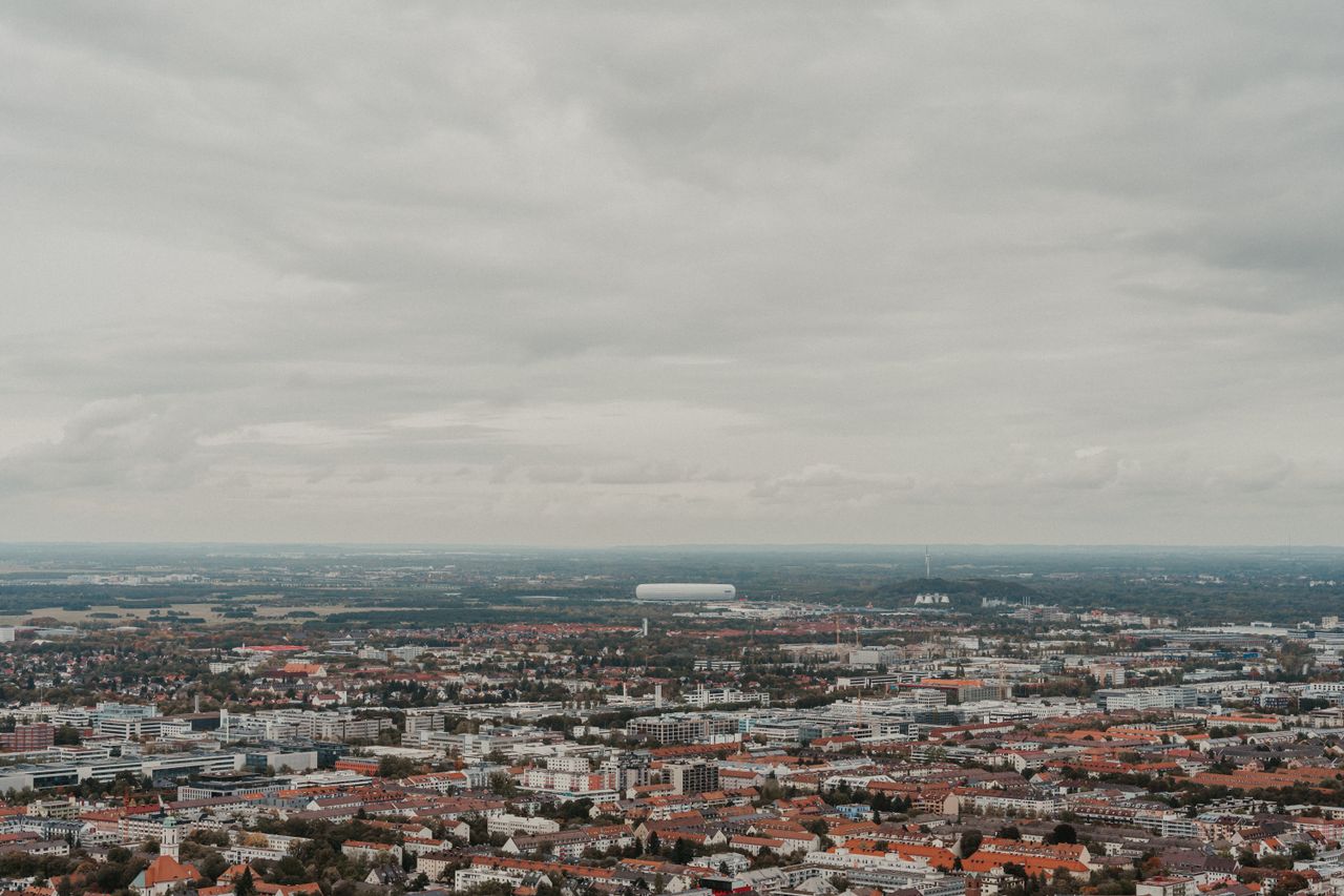 an expansive aerial view of a cityscape under an overcast sky offering