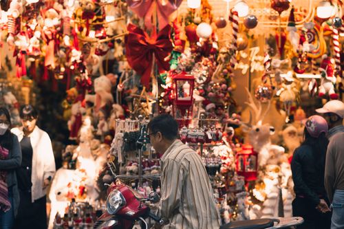 Free Colorful Christmas market bustling with people and festive decorations, perfect for holiday inspiration. Stock Photo