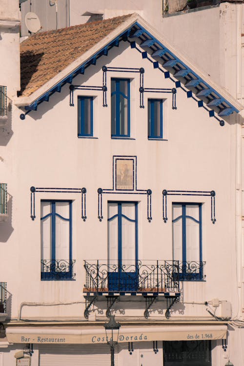 Facade of a House with a Balcony and a Tiled Roof