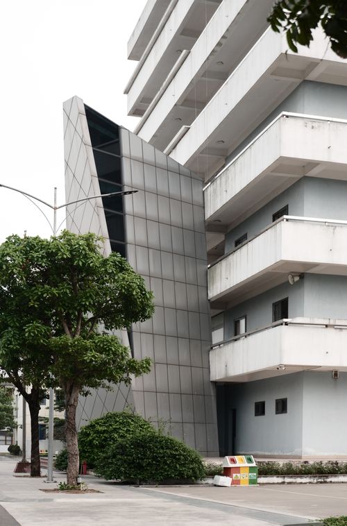 Free Contemporary building facade with balconies and geometric detailing, urban setting. Stock Photo